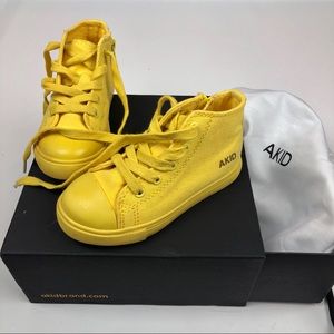 Akid brand high top sneakers.